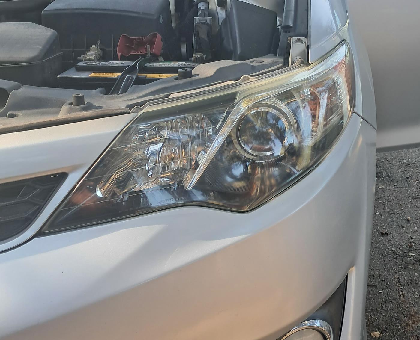 Clear Toyota Camry headlight after restoration, close angle