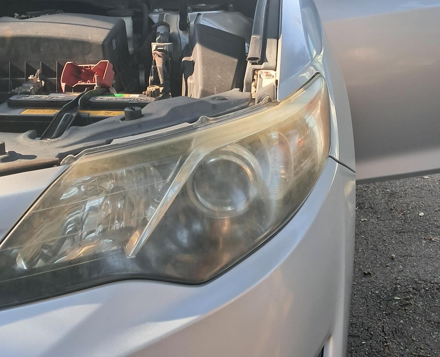 Foggy Toyota Camry headlight before restoration, close angle